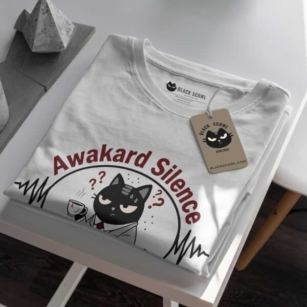 awkward-silence-tshirt-folded-tag-mockup Close-up mockup of the folded Black Scowl Awkward Silence t-shirt, showing the custom tag detail.