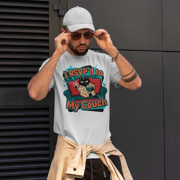 black-scowl-rsvp-couch-white-tee-man-casual asual wear: Man in a white 'I RSVP'd to My Couch' t-shirt and baseball cap.