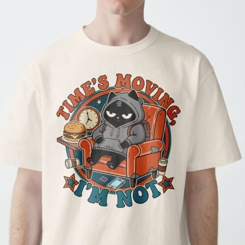 Zoom view of Black Scowl cat on a beige t-shirt, saying 'Time's Moving. I'm Not.'