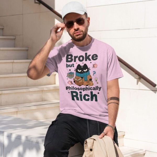 Street style: Man wearing a pink t-shirt with the 'Broke but Philosophically Rich' design.