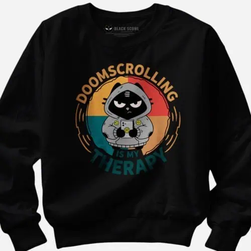Detail view mockup of the Black Scowl doomscrolling sweatshirt graphic, focusing on the grumpy cat.