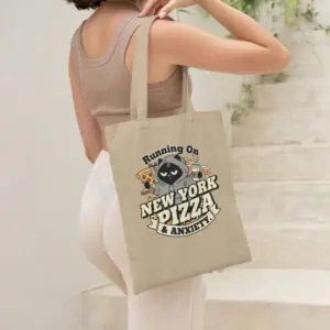 Young woman (Gen Z) carrying the sarcastic "Running On Anxiety" tote bag in an urban setting.