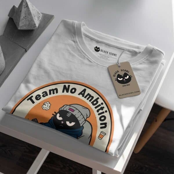 team-no-ambition-tshirt-folded-tag-mockup Close-up mockup of the folded Black Scowl "Team No Ambition" t-shirt, showing the custom tag detail.