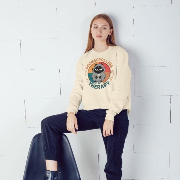 woman-doomscrolling-sweatshirt-phone Woman wearing a Black Scowl doomscrolling sweatshirt, checking her phone.