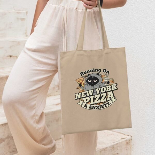 woman-with-new-york-pizza-anxiety-tote Introvert woman walking with the Oyster-colored Black Scowl anxiety tote bag, ideal for daily cynicism.