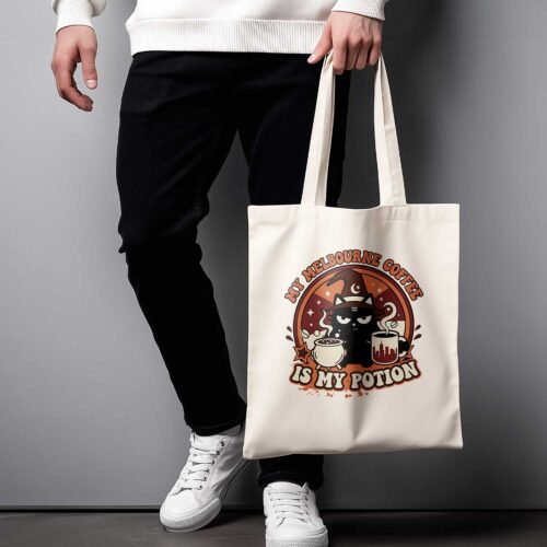 funny-cat-tote-bag-female-model-melbourne Female model holding the "My Melbourne Coffee Is My Potion" tote bag, showcasing the size and fit for daily use.