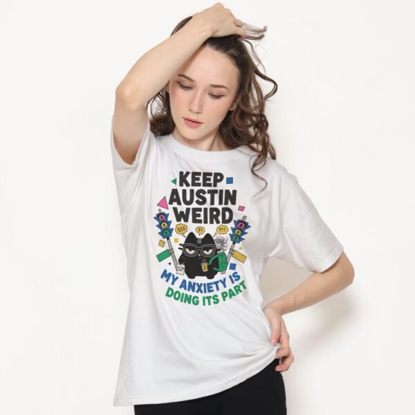 Lifestyle shot of a Black Scowl sarcastic tee. Illustration of a black cat with glasses experiencing social anxiety and burnout.