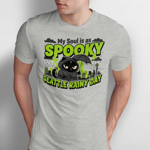 Black Scowl graphic tee featuring a grumpy black cat in a raincoat holding an umbrella with Seattle Space Needle in background.