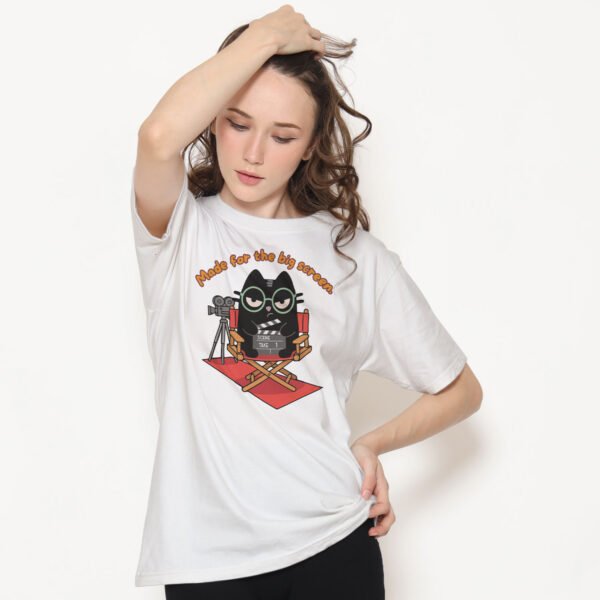 Model wearing white t-shirt with sarcastic director cat design, trendy outfit for film students and movie buffs.