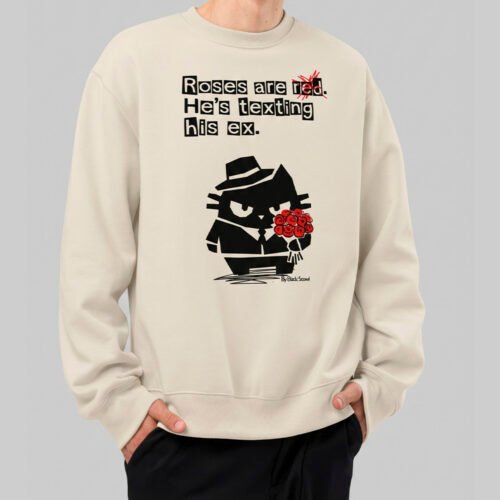 Front view of a model wearing the Black Scowl beige streetwear sweatshirt, featuring an edgy urban graphic of a cat in a suit and the cynical quote "Roses are red. He's texting his ex."