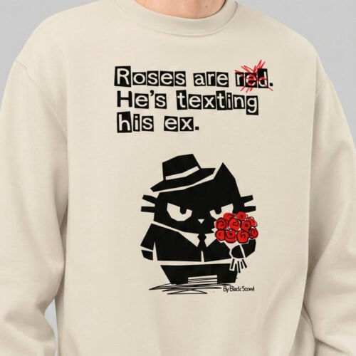 Close-up detail of the Black Scowl ironic graphic apparel design on a cream crewneck, highlighting the anti-valentine humor, bold typography, and grumpy cat holding roses.
