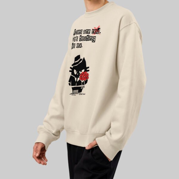 Side angle view of a model showcasing the relaxed fit of the Black Scowl modern urban clothing sweatshirt in beige, featuring dark humor streetwear aesthetics.