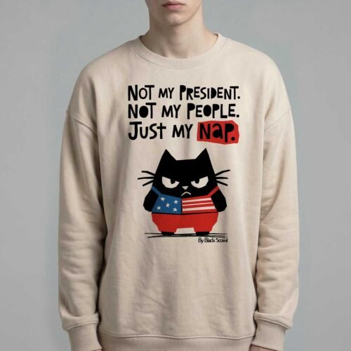 Male model wearing Black Scowl heavyweight oversize sweatshirt with a sarcastic political quote Not My President and a cynical cat graphic.