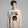 Male model wearing Black Scowl heavyweight oversize sweatshirt with a sarcastic political quote Not My President and a cynical cat graphic.