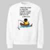 Full flat lay view of the white Black Scowl crewneck. This edgy streetwear piece features a dark humor cat graphic and an antisocial quote, essential for modern urban apparel.