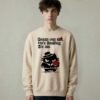 Male model wearing Black Scowl heavyweight oversize sweatshirt with a sarcastic quote about a toxic ex and a cynical cat holding red roses.