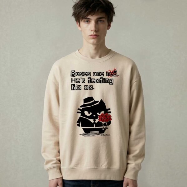 Male model wearing Black Scowl heavyweight oversize sweatshirt with a sarcastic quote about a toxic ex and a cynical cat holding red roses.