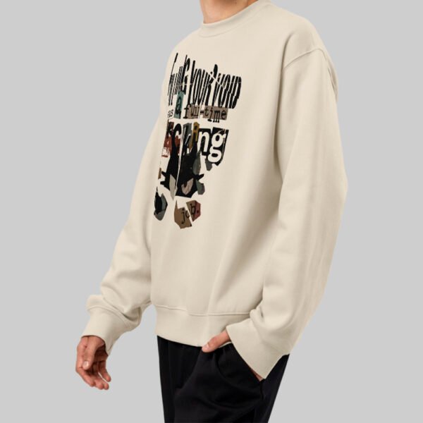 Side angle of the Black Scowl beige sweatshirt on a model, highlighting the relaxed fit of this modern fashion streetwear piece.