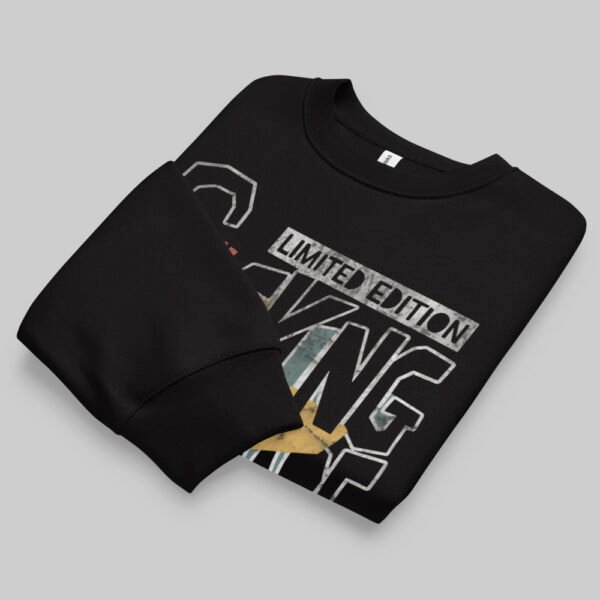 A professionally folded Black Scowl black crewneck sweatshirt on a gray background, showcasing the top portion of the "Fcking Nightmare" graphic design.