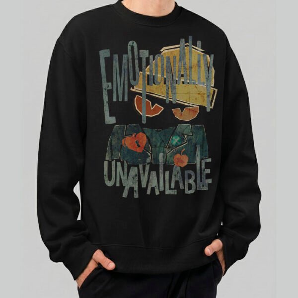 A male model wearing a Black Scowl black heavyweight crewneck with a distressed "Emotionally Unavailable" graphic in a vintage urban streetwear style.