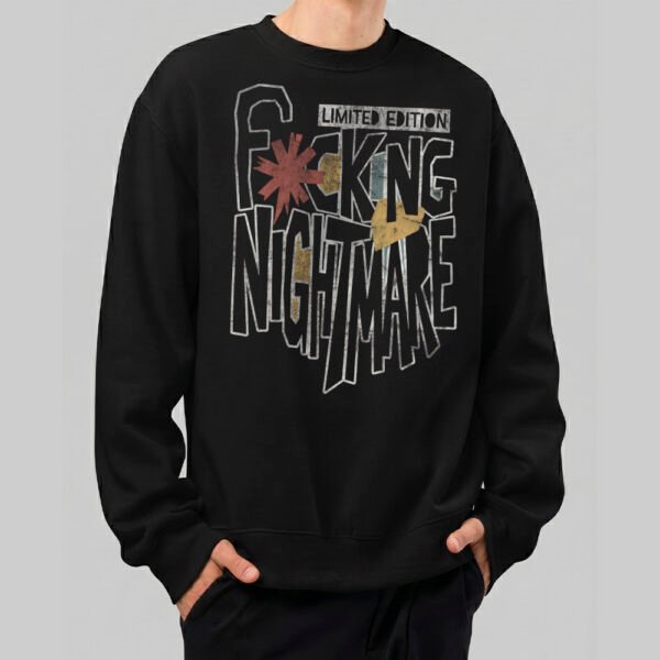 Front view of a male model wearing a Black Scowl black heavyweight crewneck featuring a bold "Fcking Nightmare" typographic graphic in a distressed streetwear style.
