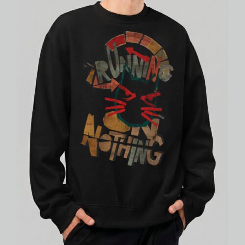 Front view of a male model wearing a Black Scowl black heavyweight crewneck featuring a distressed "Running on Nothing" urban graphic with a cynical cat character.