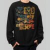 Front view of a male model wearing the Black Scowl oversized black sweatshirt with a vibrant, vintage-inspired "Zero Energy" streetwear graphic.