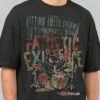 Close-up zoom of the high-quality graphic on a Black Scowl black oversized t-shirt highlighting the distressed vintage-style print of the drummer cat character.