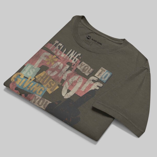 Professional flat-lay shot of a folded Black Scowl charcoal oversized graphic t-shirt highlighting the premium fabric texture and interior neck branding.