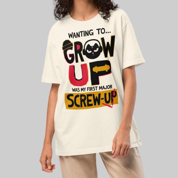 A female model wearing the Black Scowl cream heavyweight graphic tee with a cynical urban design and a relaxed, drop-shoulder avant-garde fit.