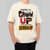 Front view of a male model wearing a Black Scowl cream heavyweight t-shirt featuring a sarcastic "Wanting To Grow Up Was My First Major Screw-Up" graphic with a grumpy cat icon.
