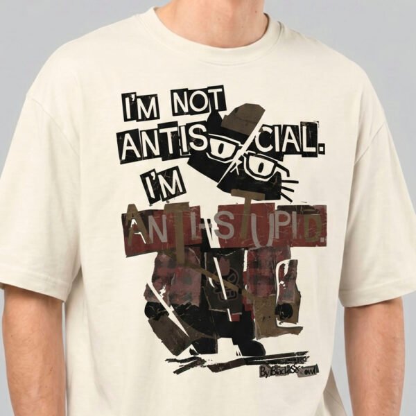 Close-up detail of the Black Scowl cream heavyweight tee showing the distressed typography and the sophisticated grumpy cat design.