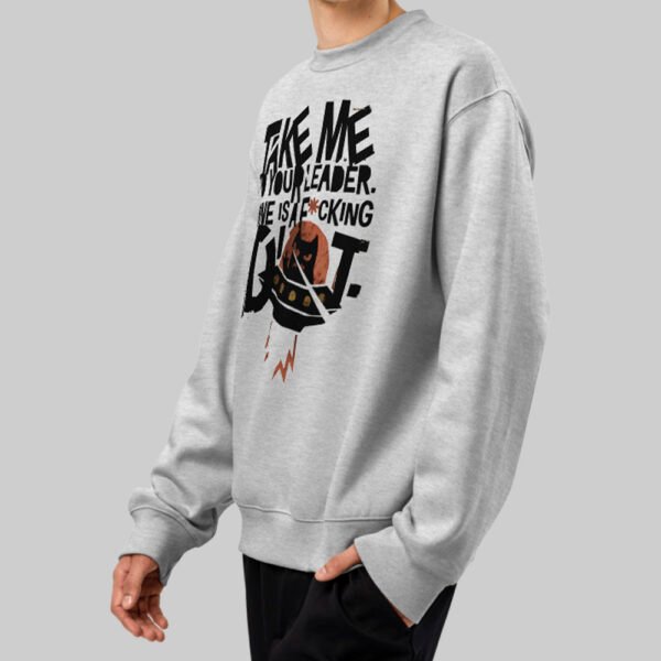 black-scowl-existential-cat-apparel-grey-side-view-lifestyle Side view of a person wearing a Black Scowl grey graphic sweatshirt with an urban streetwear aesthetic and a grumpy cat saucer design.