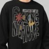 Close-up detail of the "Fcking Nightmare" limited edition graphic on a Black Scowl black sweatshirt, showing the textured font and avant-garde design elements.