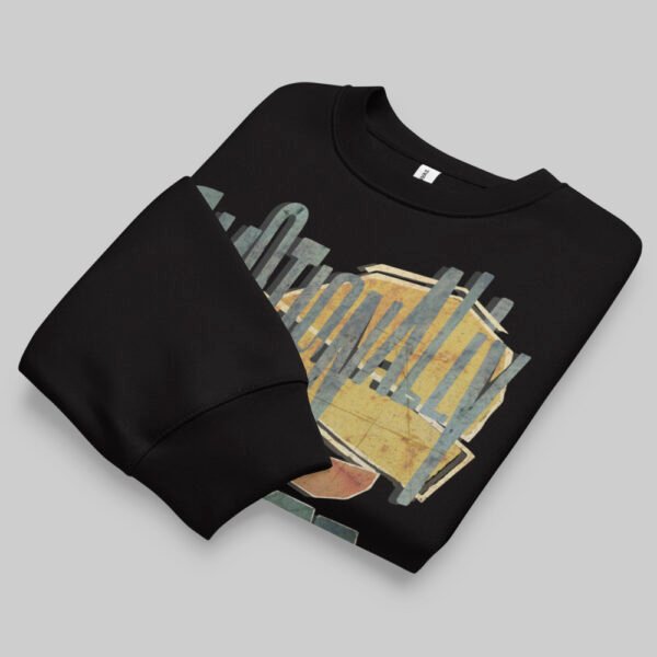 A professionally folded Black Scowl black crewneck sweatshirt on a gray background, showcasing the top portion of the graphic design.