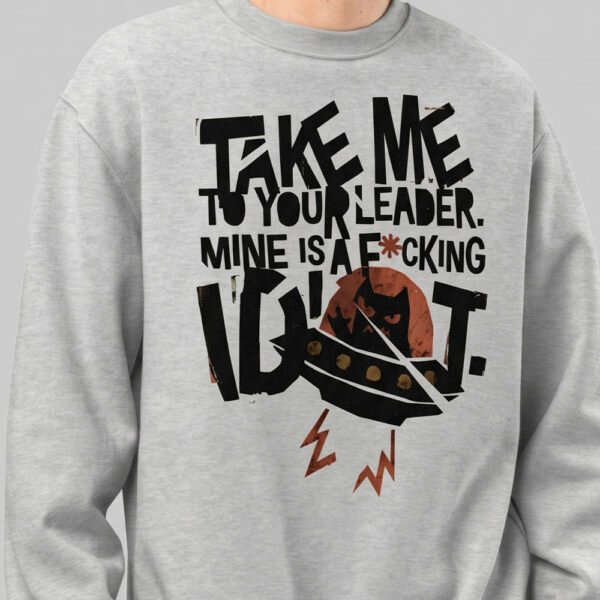 black-scowl-graphic-crewneck-urban-style-close-up-detail Close-up of the graphic print on a Black Scowl grey crewneck sweatshirt showing the distressed alien cat design and edgy typography.