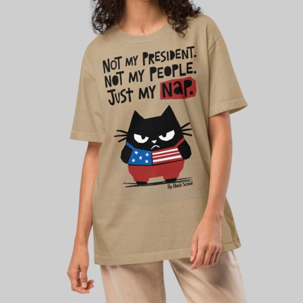 A female model wearing the Black Scowl sand oversized shirt, demonstrating the versatile unisex fit and minimalist urban streetwear style.