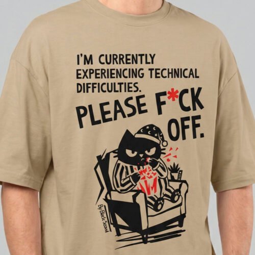 Close-up detail of the Black Scowl sand heavyweight tee showing the high-quality print of the grumpy cat character and bold cynical typography.