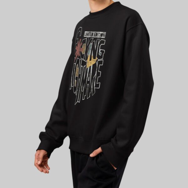 Side profile of a model wearing the Black Scowl oversized black sweatshirt, highlighting the relaxed fit and urban streetwear silhouette.