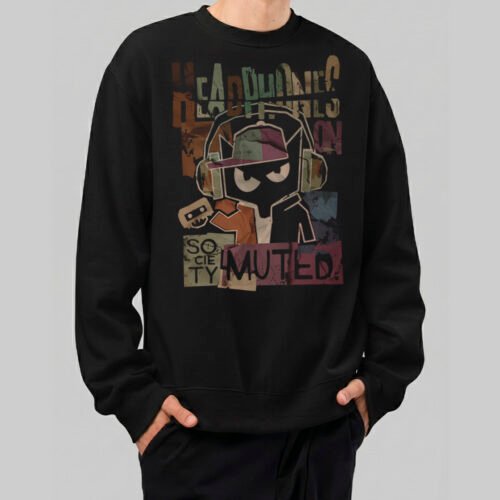 A male model wearing a Black Scowl black sweatshirt featuring a graphic of a cat with headphones and the text Society Muted in a grunge urban streetwear style.