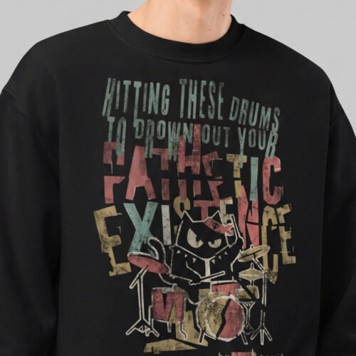 Close-up of the Black Scowl urban graphic apparel design, highlighting the distressed vintage typography and dark humor cat drummer print.