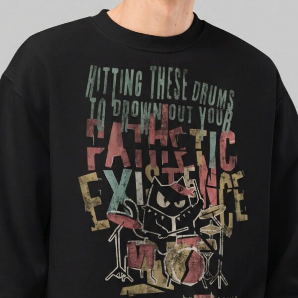 Close-up of the Black Scowl urban graphic apparel design, highlighting the distressed vintage typography and dark humor cat drummer print.