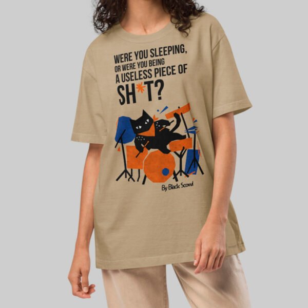 A female model wearing the Black Scowl sand oversized shirt, demonstrating the versatile unisex fit and minimalist urban streetwear style.