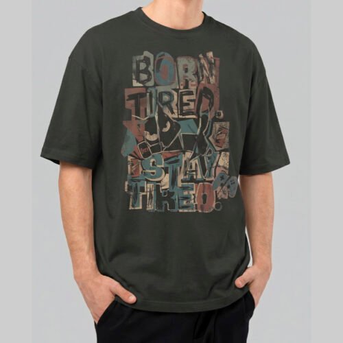 Front view of a male model wearing a Black Scowl washed black oversized t-shirt featuring a colorful "Born Tired Stay Tired" abstract graffiti design.