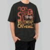 Model wearing a Black Scowl premium 220g oversized black t-shirt with a distressed graphic featuring a cat with sunglasses and '90% Spite 10% Cheap Caffeine' text.