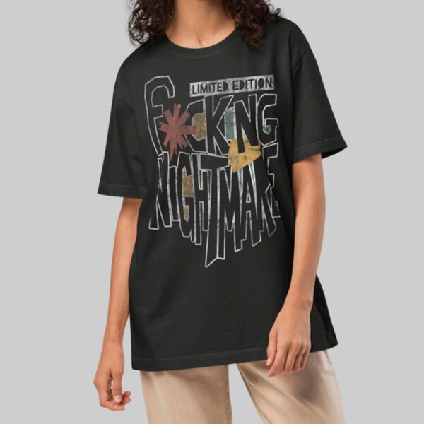 A female model wearing the Black Scowl black heavyweight graphic tee with a modern oversized fit and cynical avant-garde urban style.