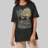 A female model wearing the Black Scowl black heavyweight graphic tee with a modern oversized fit and cynical minimalist style.