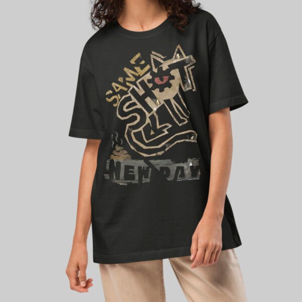 A female model wearing the Black Scowl black heavyweight graphic tee with a modern oversized fit and avant-garde aesthetic.