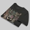 Professional flat-lay shot of a folded Black Scowl black oversized graphic t-shirt showing the interior branding and high-quality 220g cotton texture.