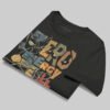 Professional flat-lay shot of a folded Black Scowl black oversized graphic t-shirt showing the interior neck label and high-quality 220g cotton texture.